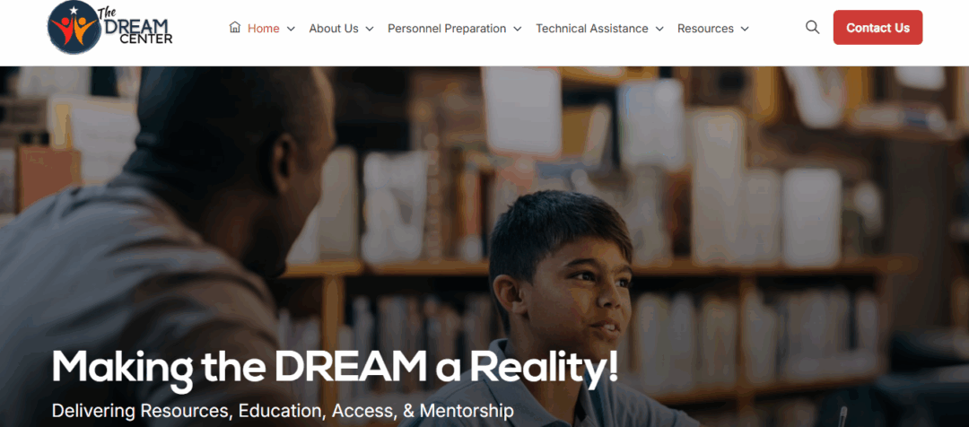 Adult mentor working with a young student in a library setting, representing the DREAM Center’s mission to provide resources, education, access, and mentorship to strengthen special education programs.